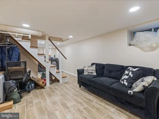 a living room with furniture and stairs
