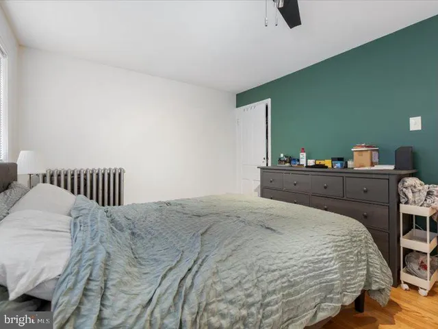 a bedroom with a bed and dresser