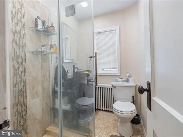 a bathroom with a toilet a sink and shower