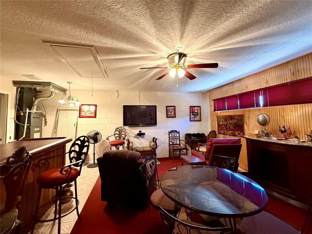 15425 Southwest 14th Avenue Road Ocala, FL 34473 - Photo 15 of 21 a living room with furniture a flat screen tv and kitchen view