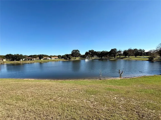 a view of a lake with houses in the background