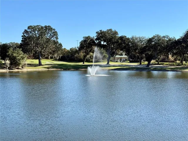 a view of swimming pool with outdoor seating and yard in the back