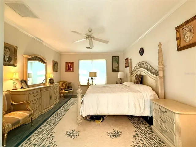 a spacious bedroom with a bed a couch and dresser