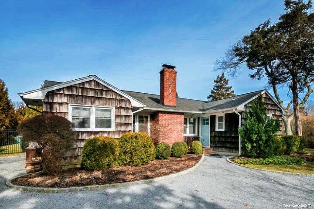4 Godfrey Lane Remsenburg, NY 11960 - Photo 1 of 1 a front view of a house with a yard