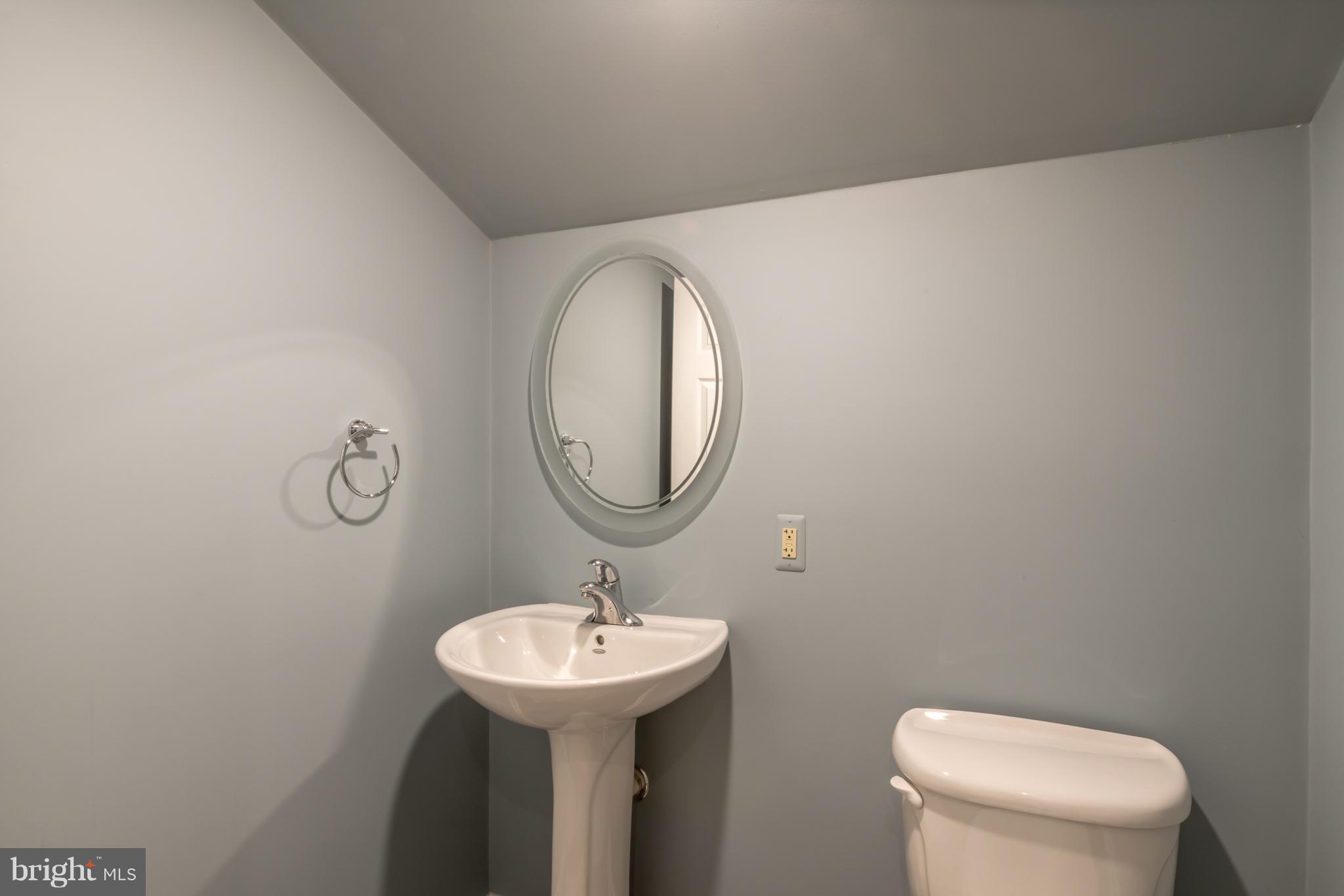 3314 Holland Cliffs Road Huntingtown, MD 20639 - Photo 22 of 30 a bathroom with a toilet sink and mirror