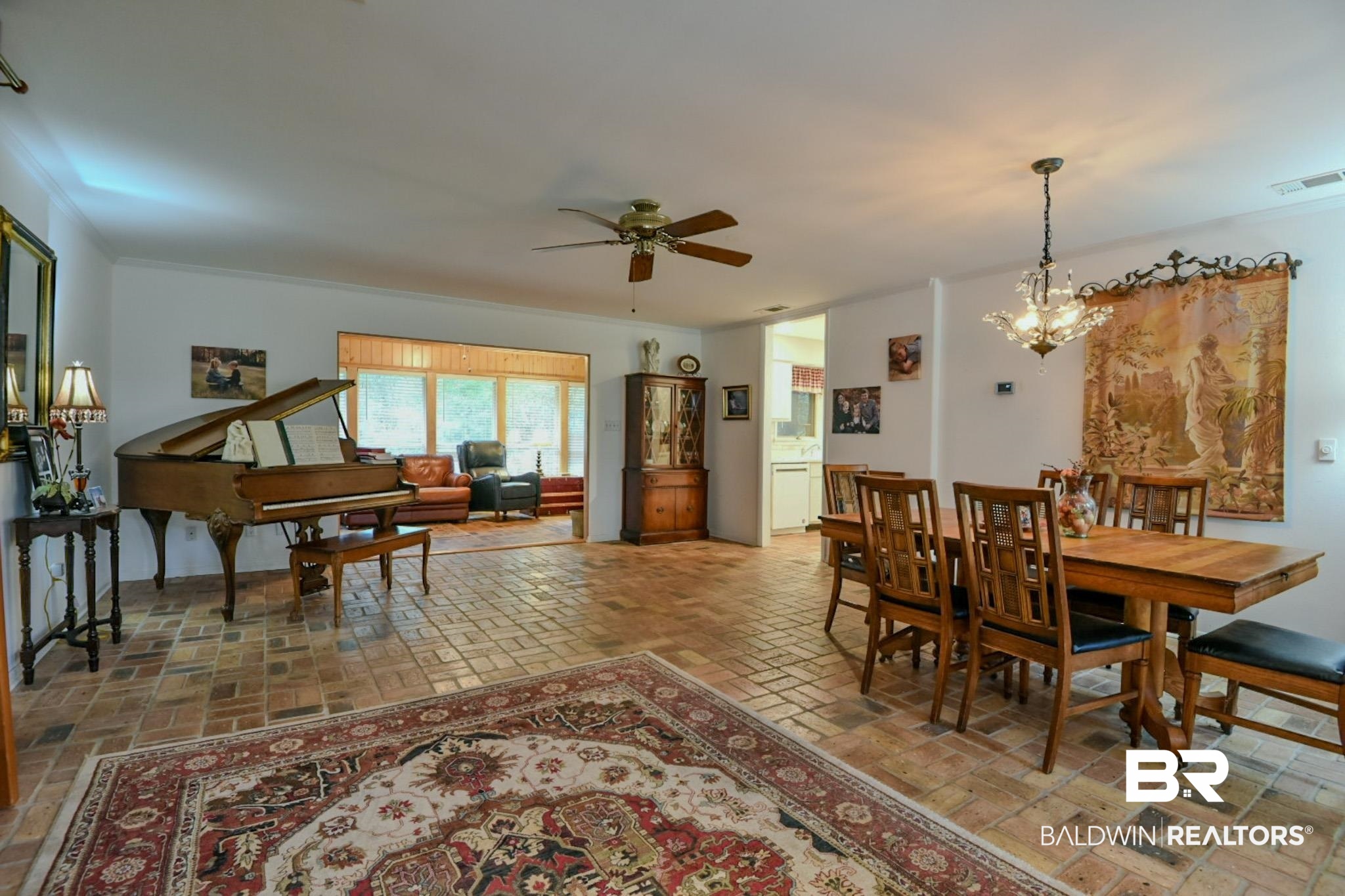 90 Paddock Drive Fairhope, AL 36532 - Photo 4 of 23 Dining space featuring a chandelier, a ceiling fan, and brick floors