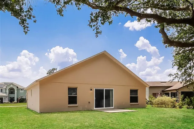 a view of a house with a backyard