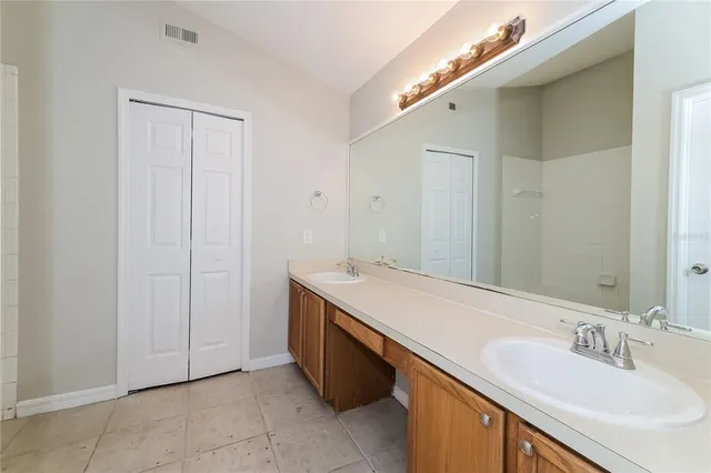 a bathroom with a double vanity sink and mirror