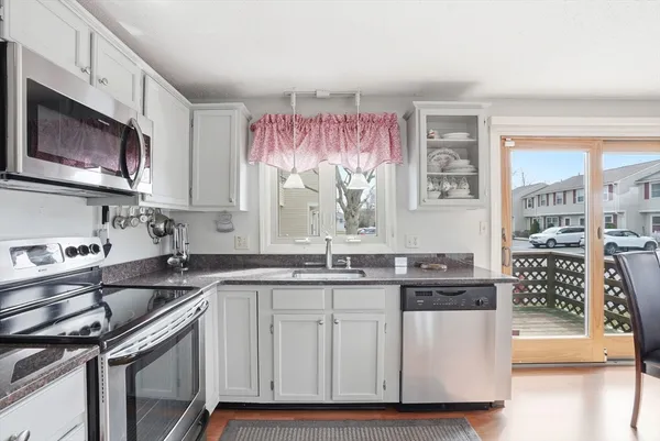 a kitchen with stainless steel appliances a sink stove and cabinets