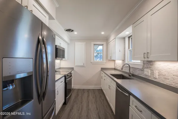 a kitchen with a sink and a window