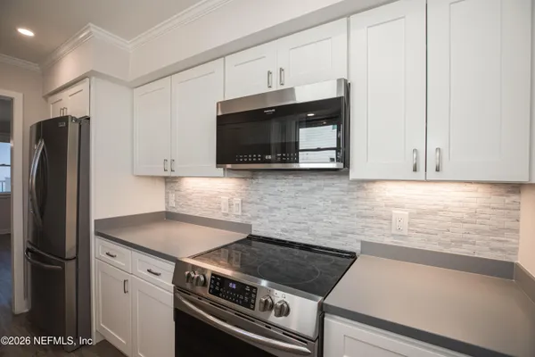 a kitchen with a sink cabinets and window