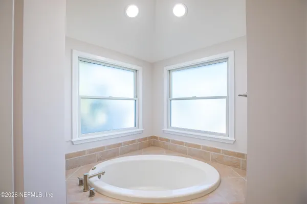 a view of a balcony with wooden floor and fence