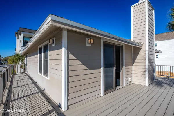 a view of a house with wooden deck