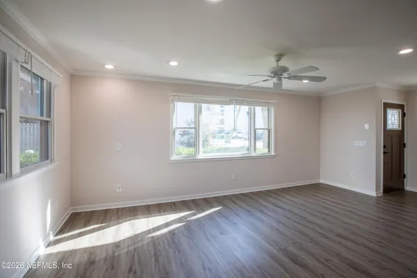 wooden floor in an empty room with a window