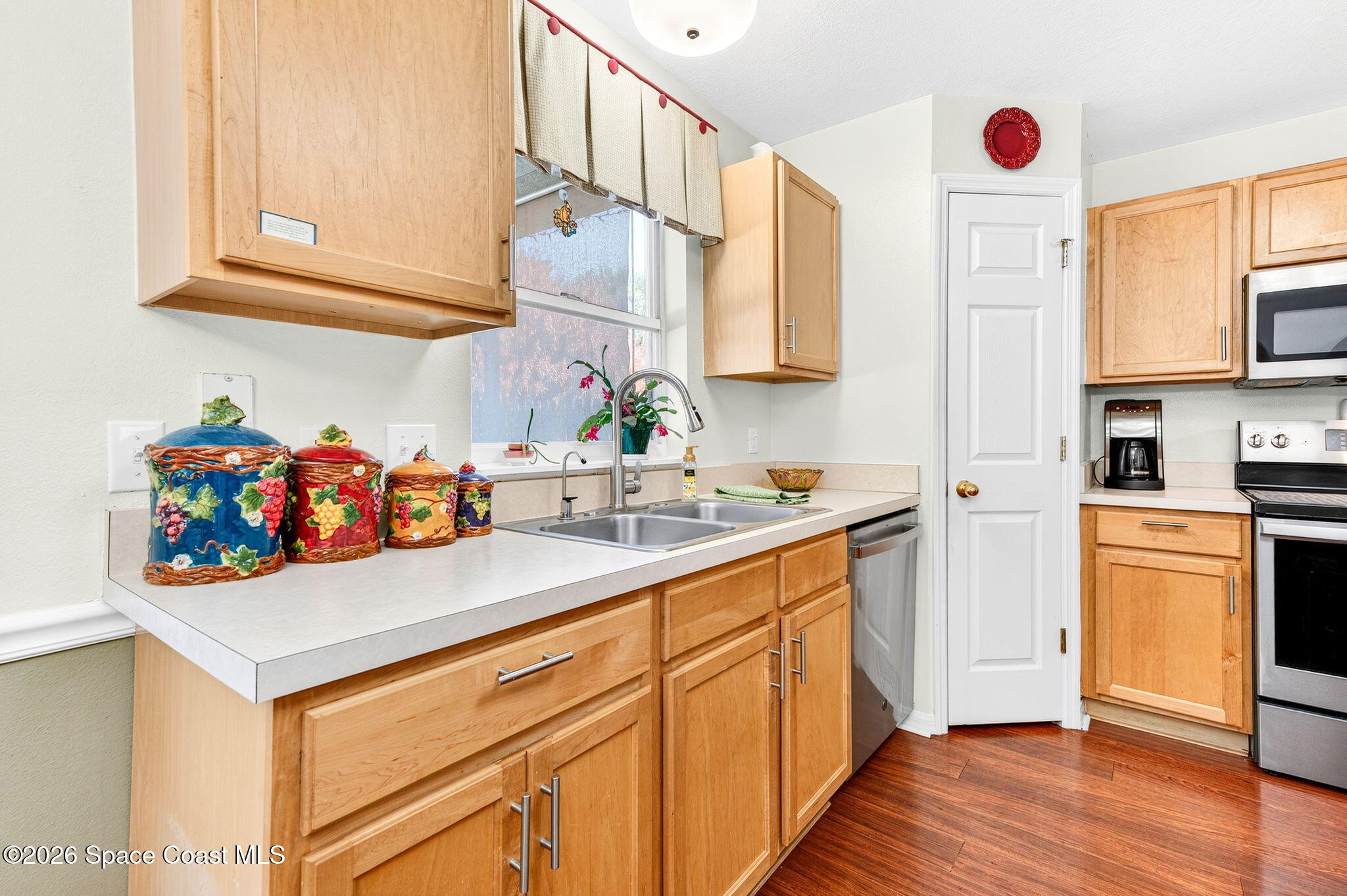 2186 Spring Creek Circle Palm Bay, FL 32905 - Photo 11 of 40 a utility room with cabinets a washer and dryer