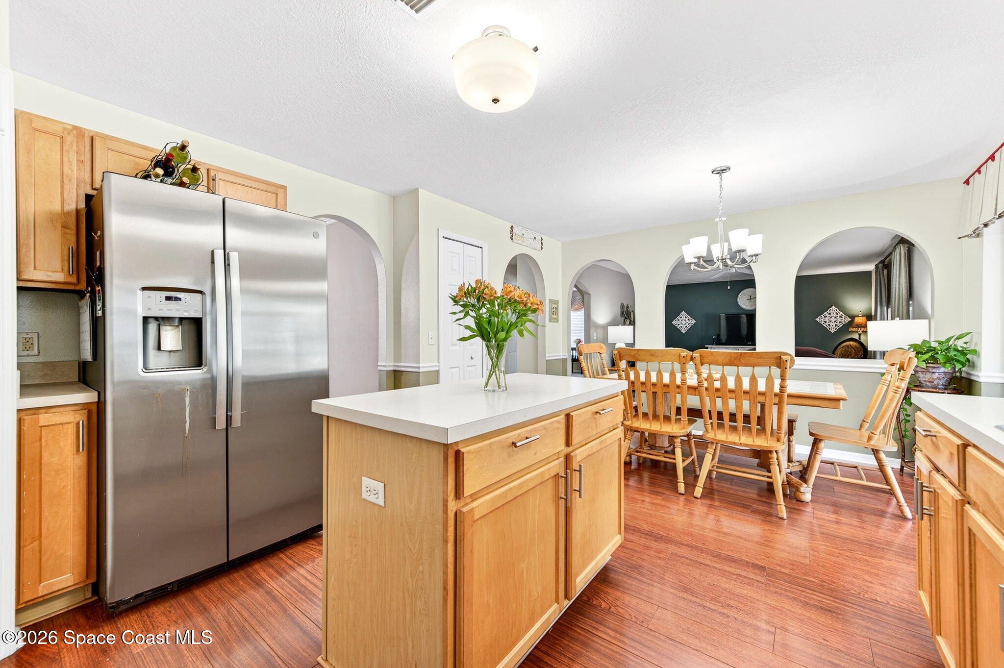 2186 Spring Creek Circle Palm Bay, FL 32905 - Photo 13 of 40 a kitchen with stainless steel appliances a dining table chairs and chandelier