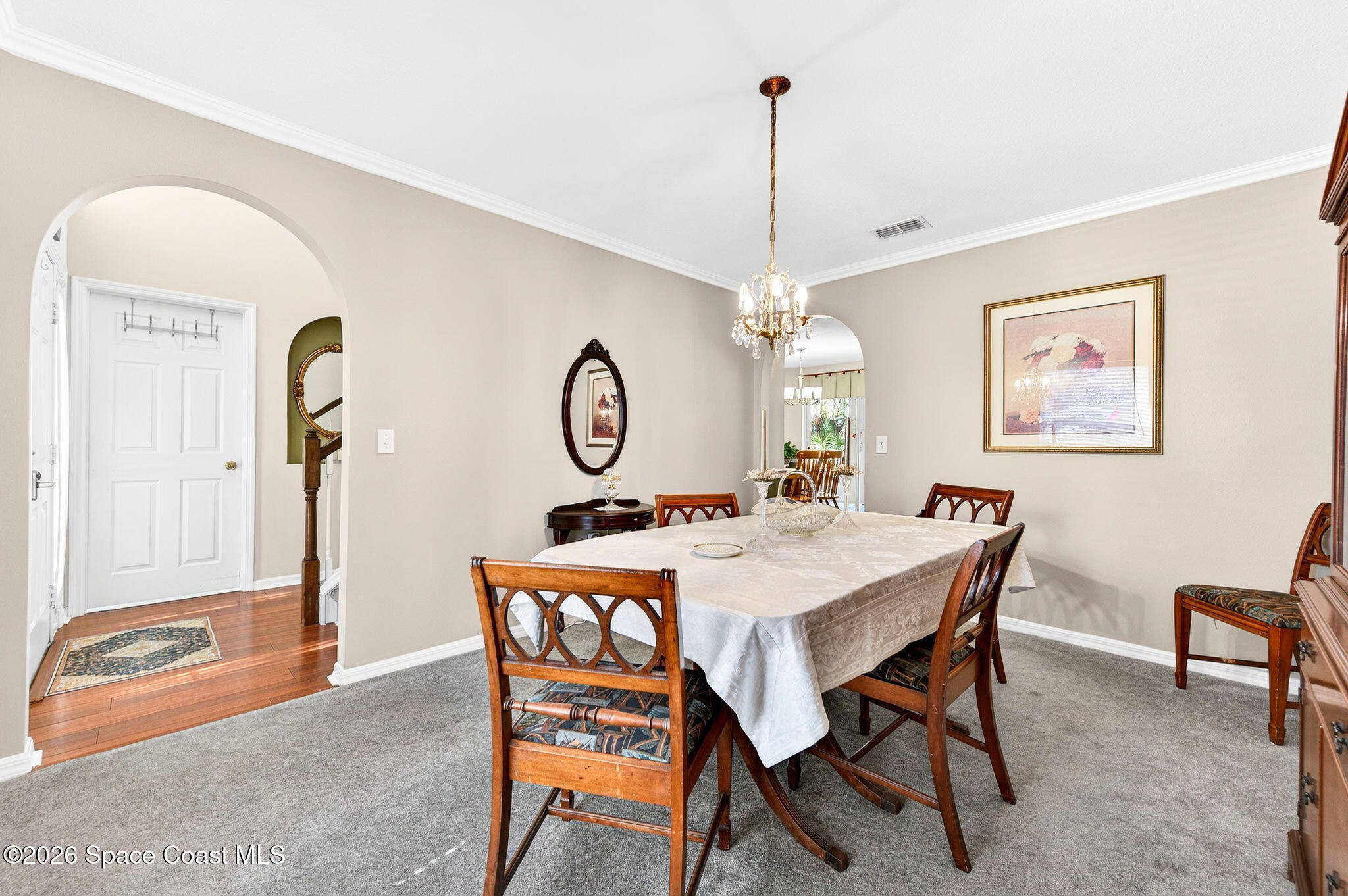 2186 Spring Creek Circle Palm Bay, FL 32905 - Photo 15 of 40 a view of a dining room and a livingroom with furniture mirror and furniture