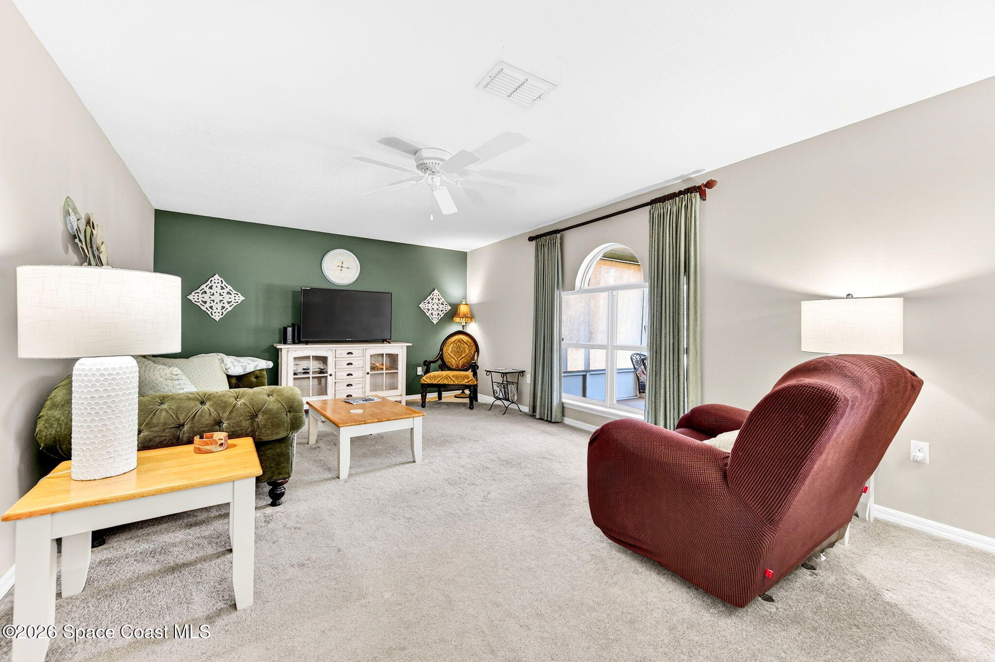 2186 Spring Creek Circle Palm Bay, FL 32905 - Photo 16 of 40 a living room with furniture and a large window