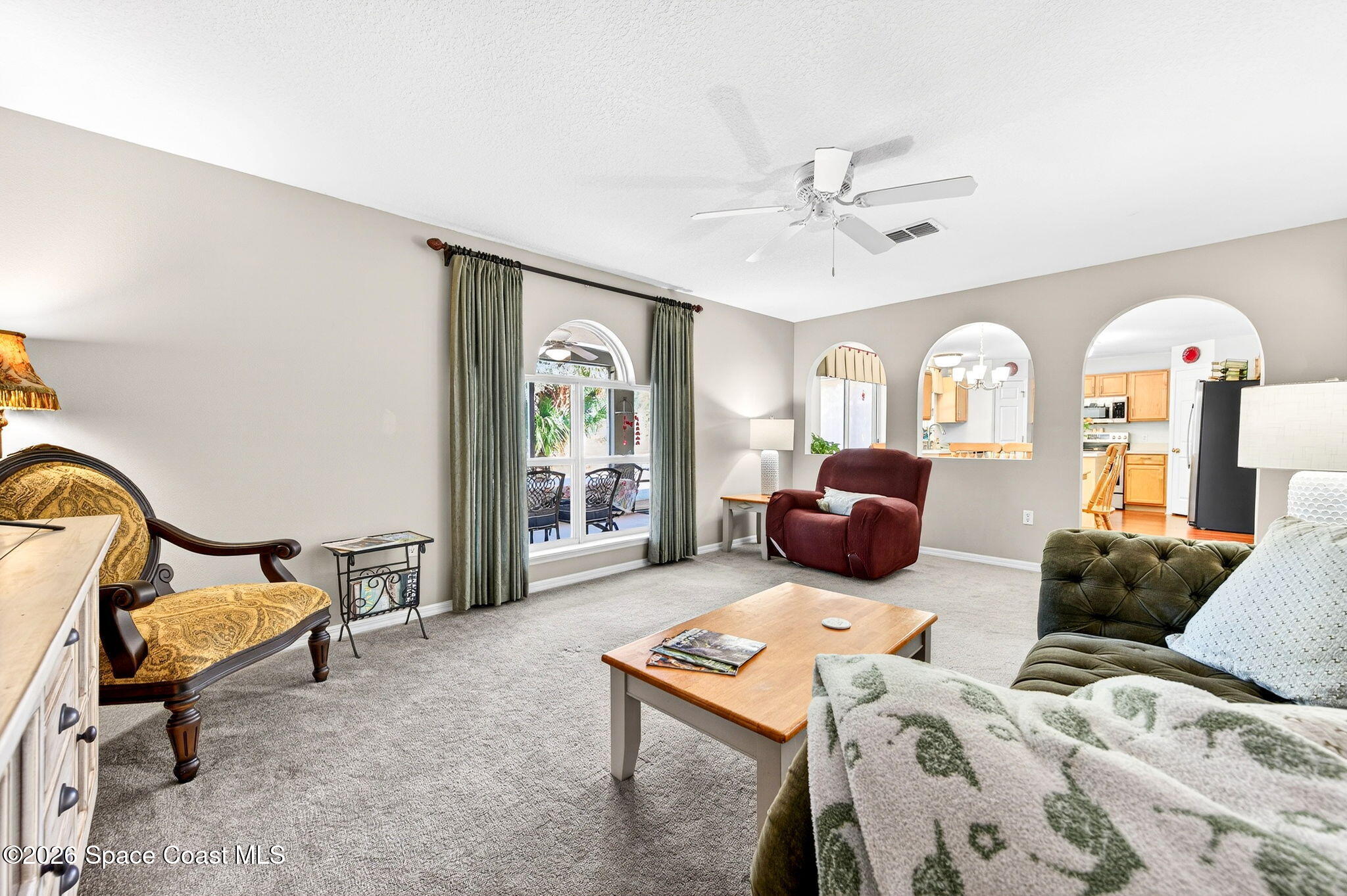 2186 Spring Creek Circle Palm Bay, FL 32905 - Photo 17 of 40 a bedroom with furniture and a chandelier