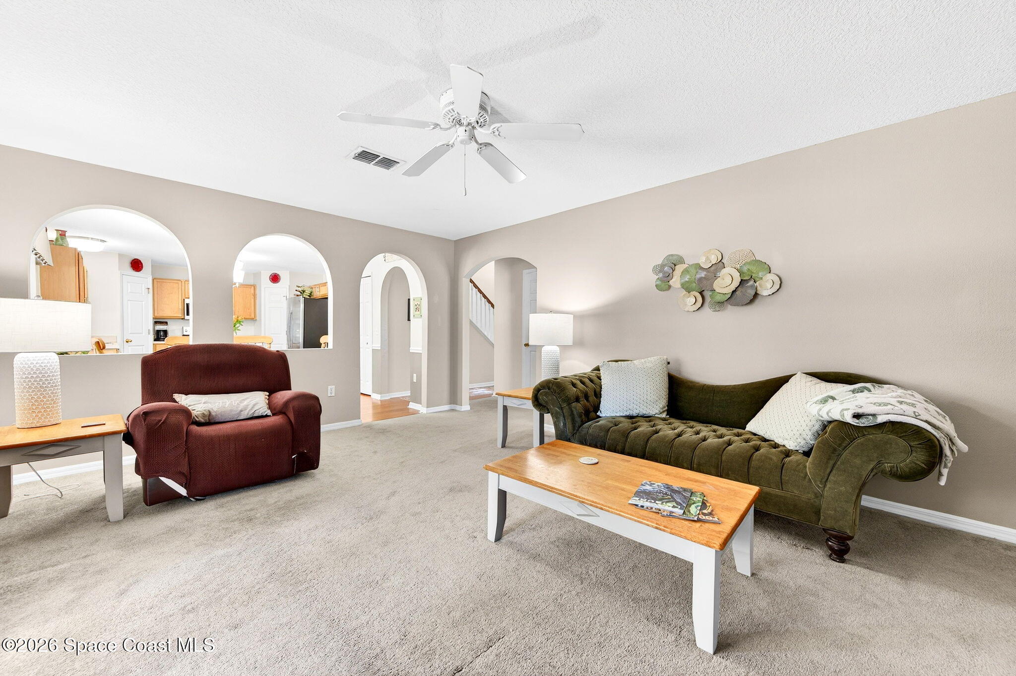 2186 Spring Creek Circle Palm Bay, FL 32905 - Photo 18 of 40 a living room with furniture and a chandelier