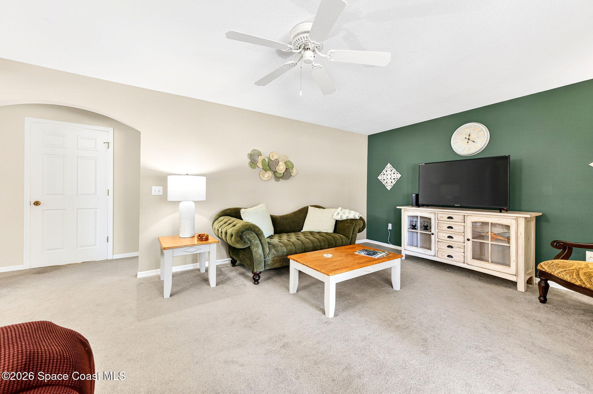 2186 Spring Creek Circle Palm Bay, FL 32905 - Photo 19 of 40 a living room with furniture and a flat screen tv
