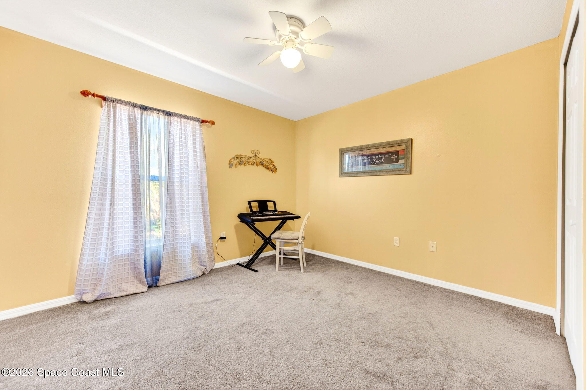 2186 Spring Creek Circle Palm Bay, FL 32905 - Photo 30 of 40 a view of a room with a window and ceiling fan