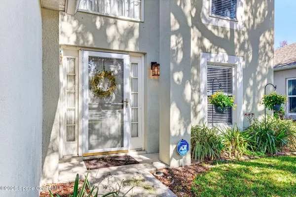 a kitchen with a refrigerator a stove top oven a sink dishwasher and white cabinets with wooden floor