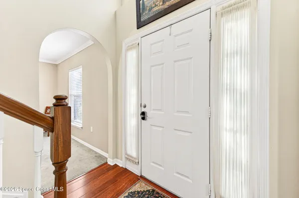 a kitchen with stainless steel appliances a dining table chairs and chandelier
