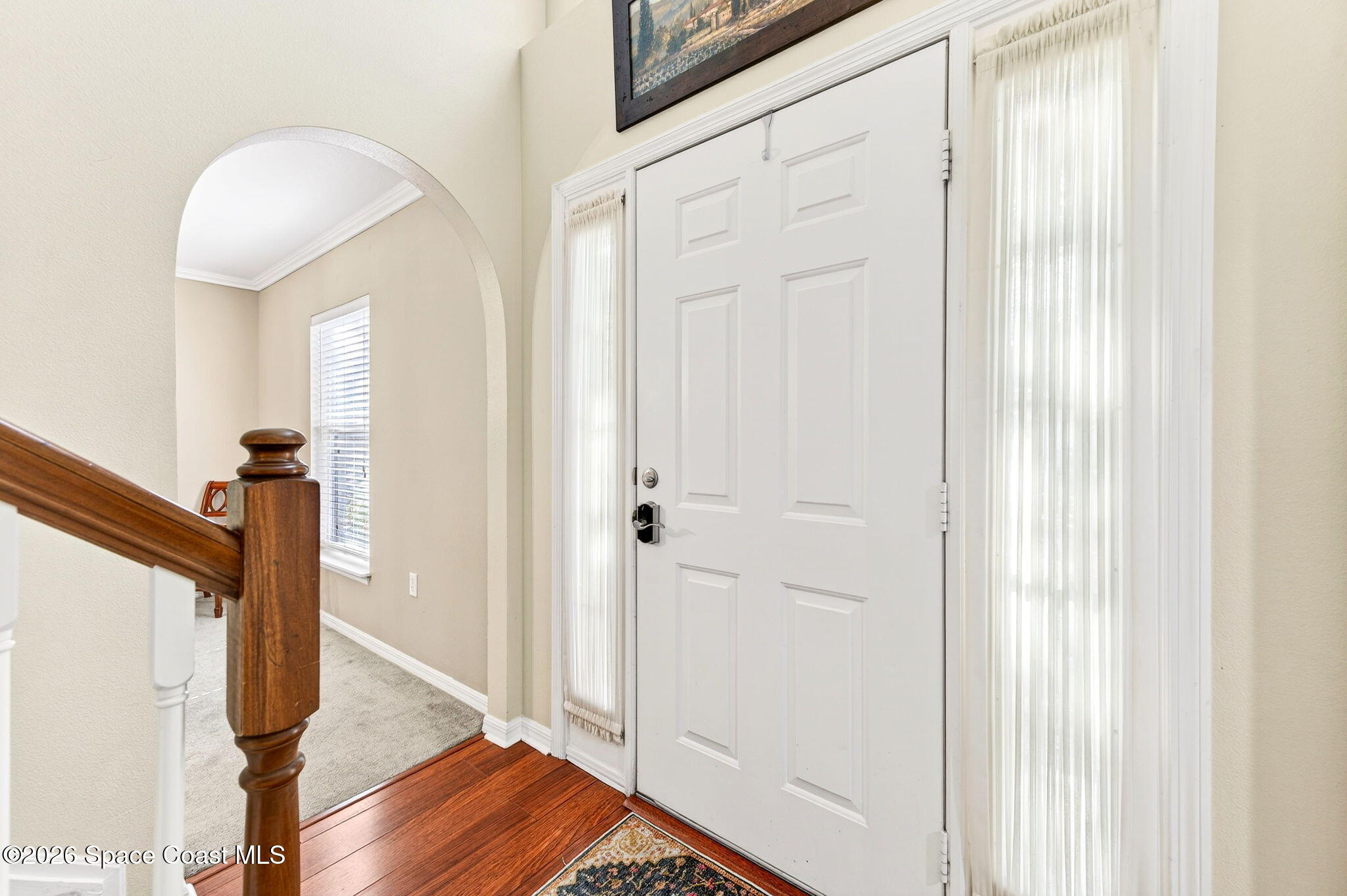 2186 Spring Creek Circle Palm Bay, FL 32905 - Photo 7 of 40 a view of a hallway with wooden floor and staircase