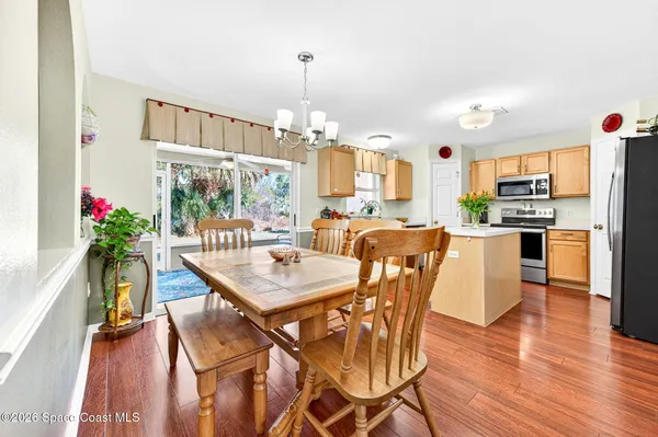 a view of a dining room and a livingroom with furniture mirror and furniture