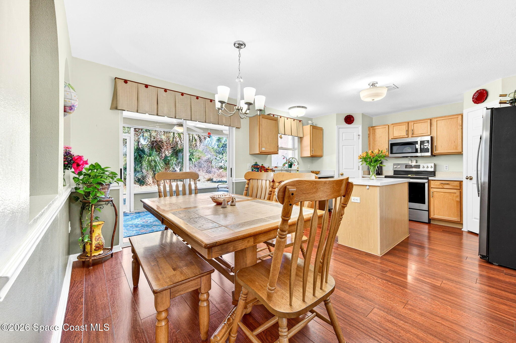 2186 Spring Creek Circle Palm Bay, FL 32905 - Photo 8 of 40 a view of a dining room with furniture and wooden floor