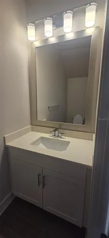 a bathroom with a sink and mirror