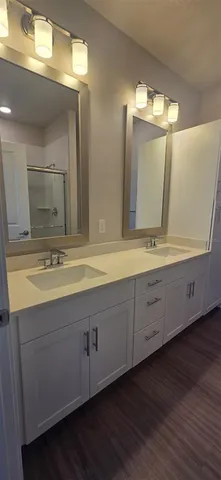 a bathroom with a double vanity sink and mirror