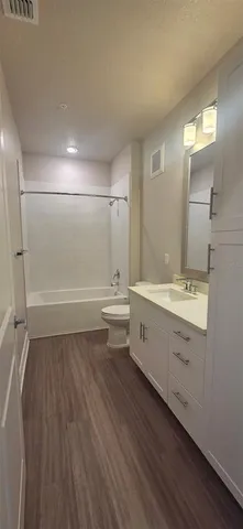 a view of a kitchen with a sink and a refrigerator