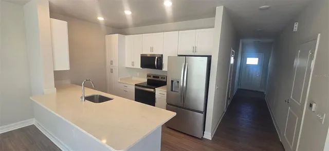 a kitchen with stainless steel appliances a refrigerator and a sink