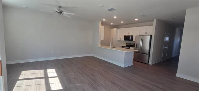 a kitchen with a refrigerator and a stove top oven