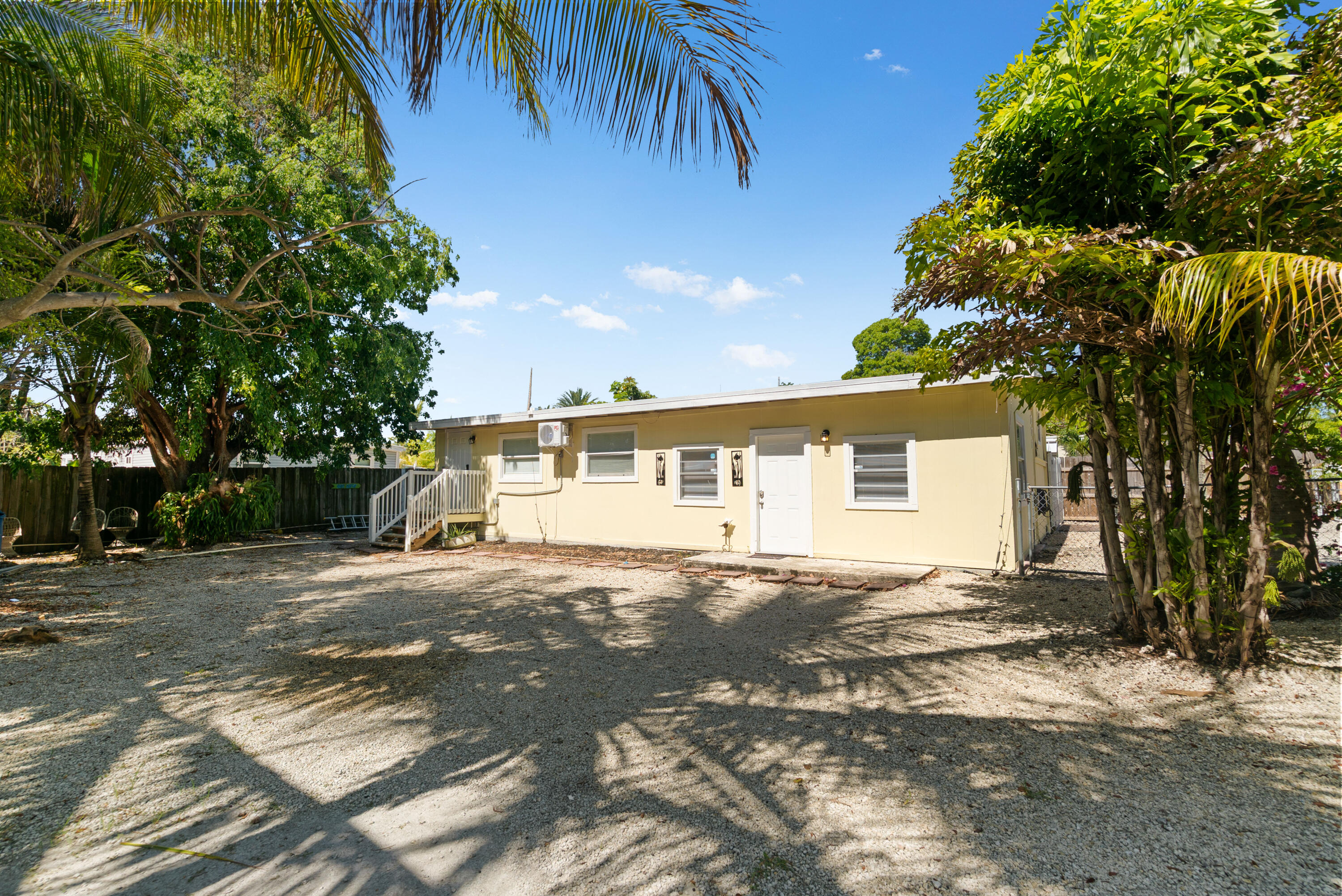 271 Ryan Avenue Key Largo, FL 33037 - Photo 1 of 58 a front view of a house with a yard and garage