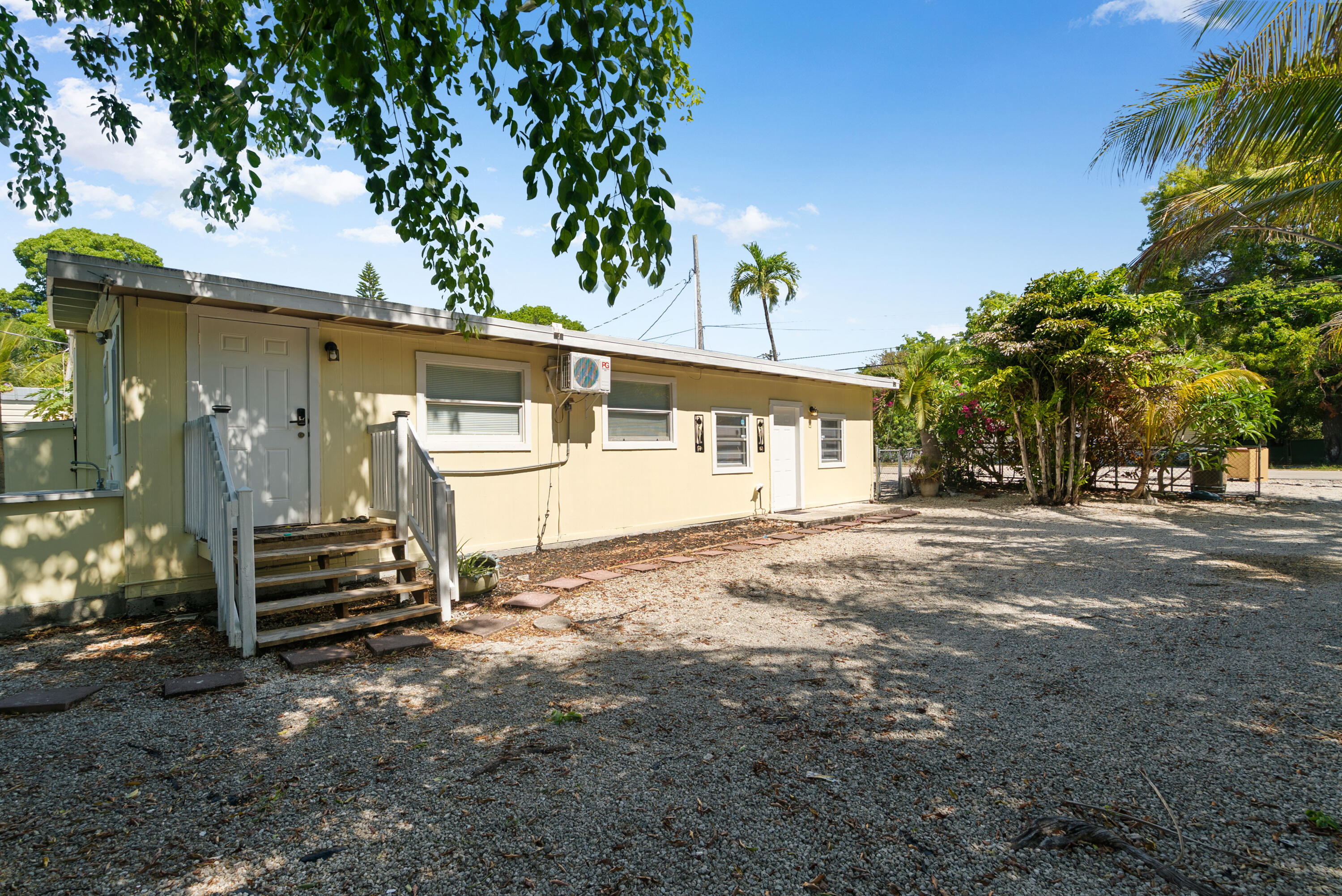 271 Ryan Avenue Key Largo, FL 33037 - Photo 2 of 58 a front view of a house with a yard