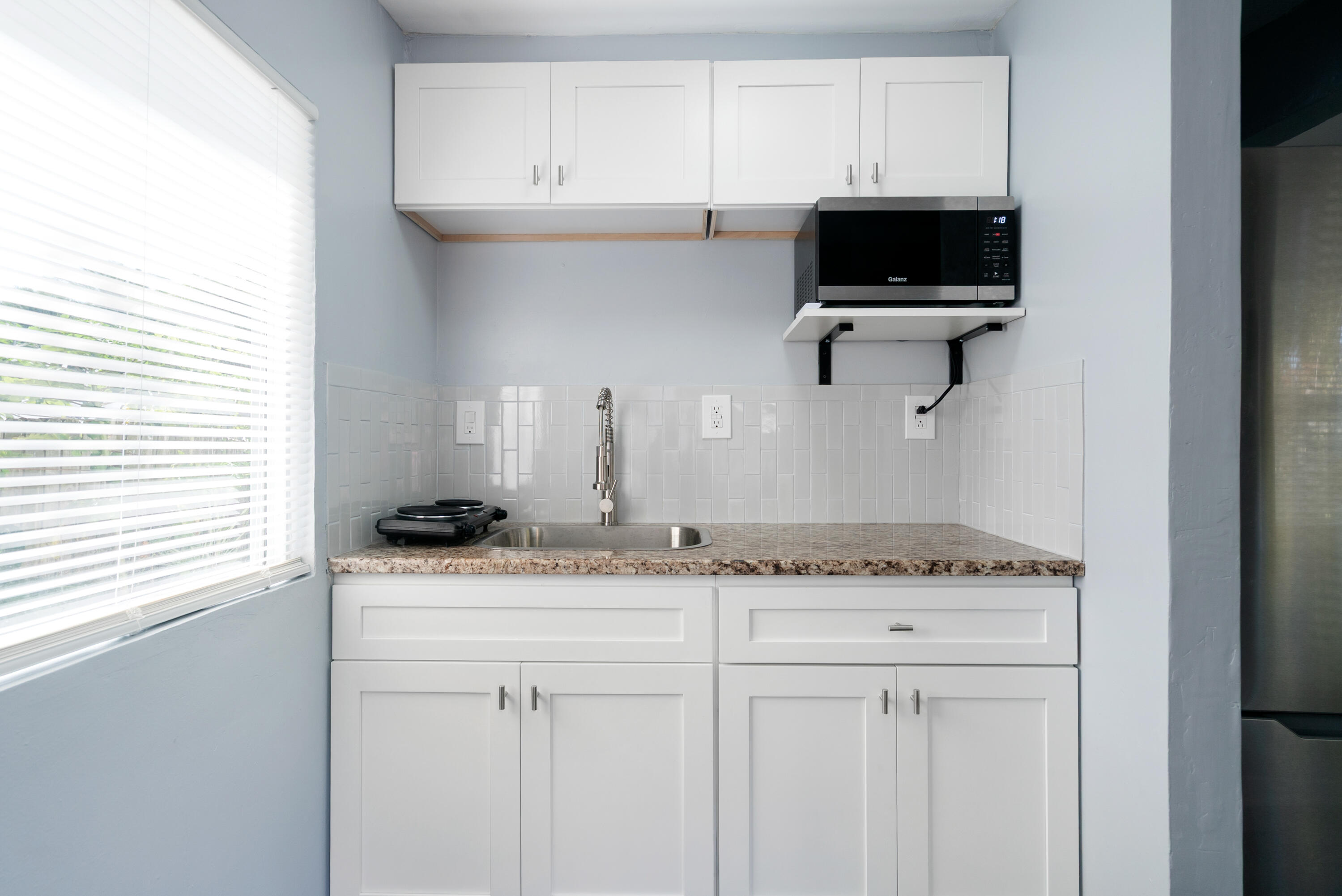271 Ryan Avenue Key Largo, FL 33037 - Photo 22 of 58 a kitchen with a sink a microwave and cabinets