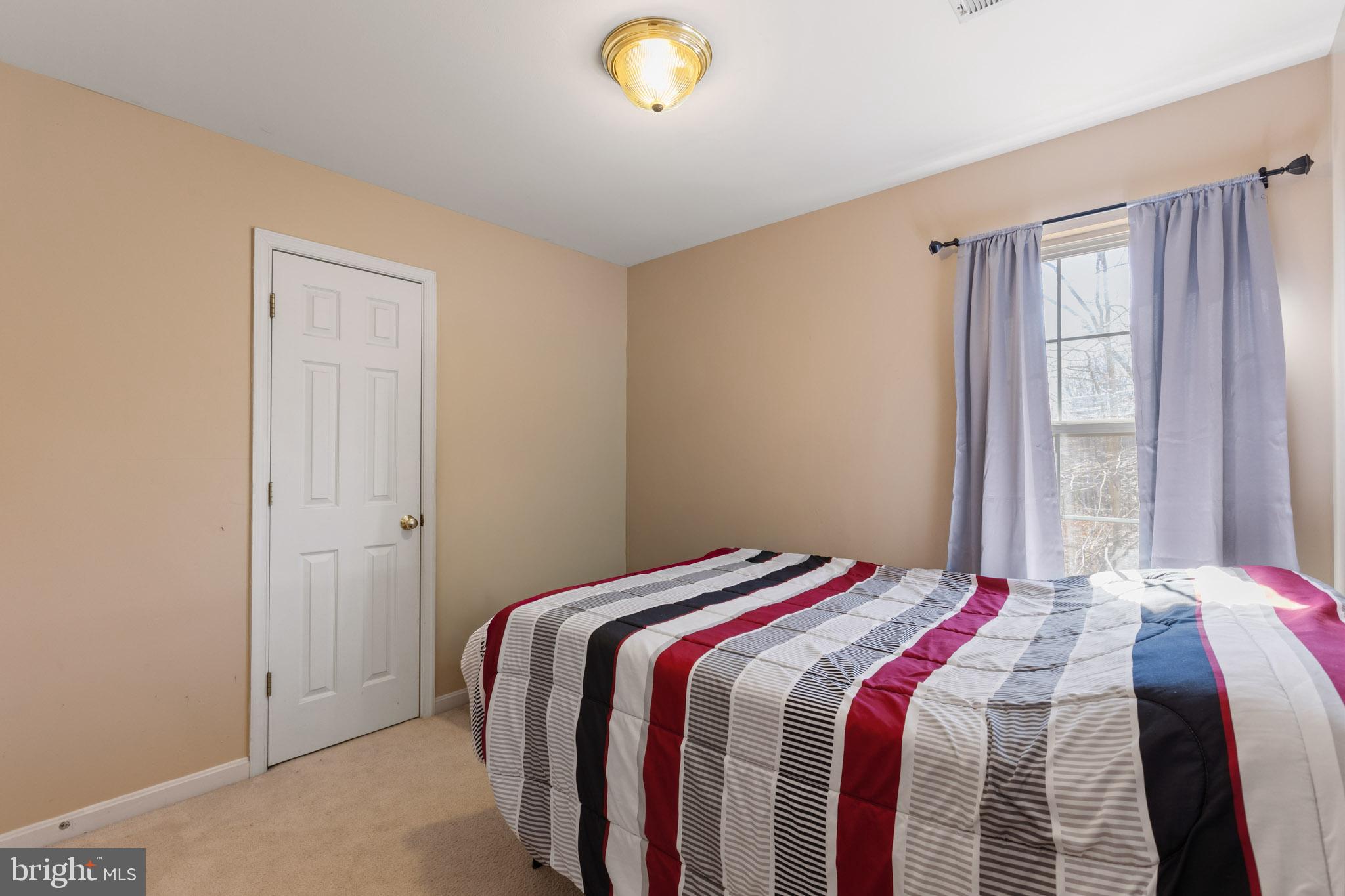 9279 Inaugural Drive King George, VA 22485 - Photo 19 of 30 a bedroom with a bed and a window