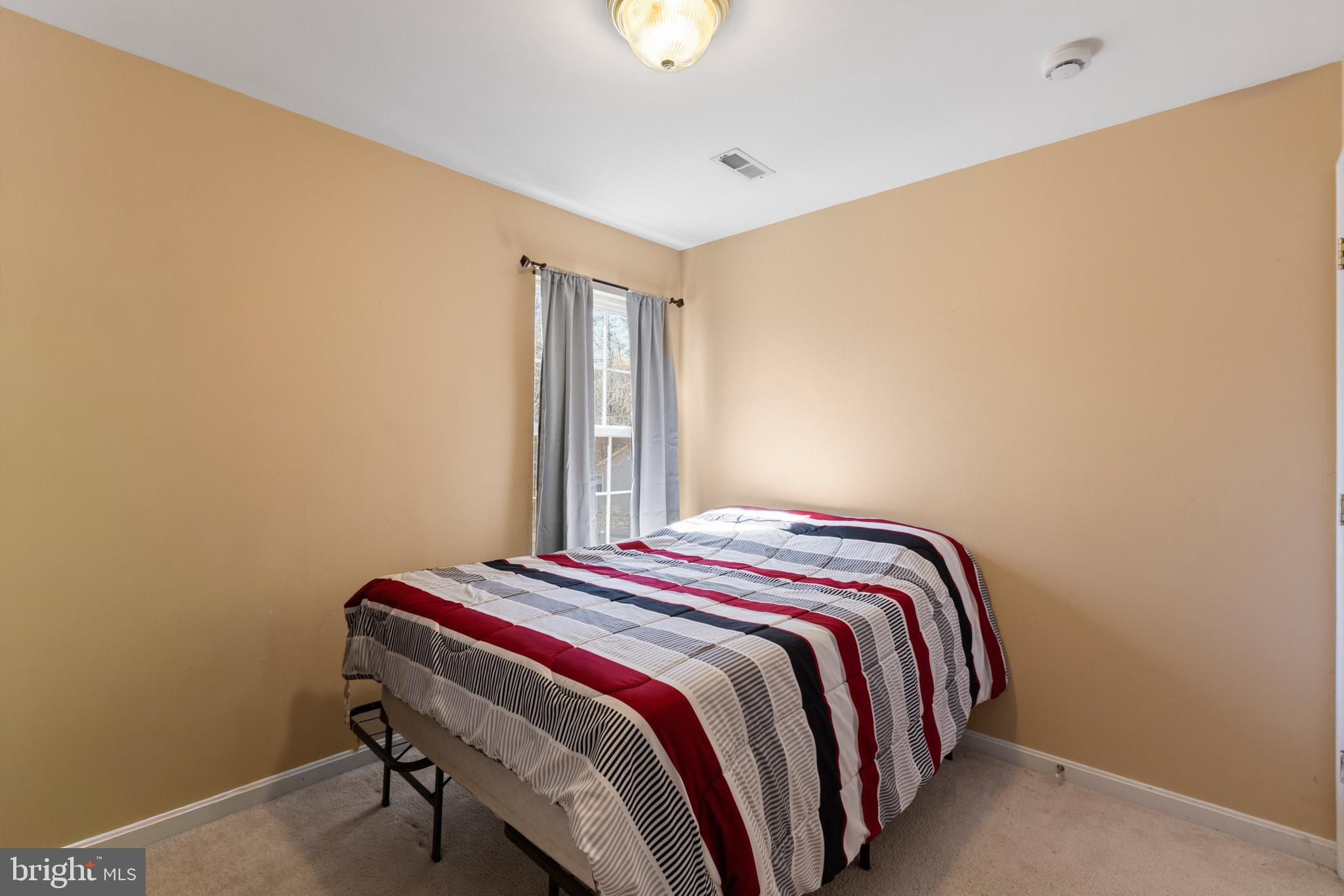 9279 Inaugural Drive King George, VA 22485 - Photo 20 of 30 a bedroom with a bed and a window
