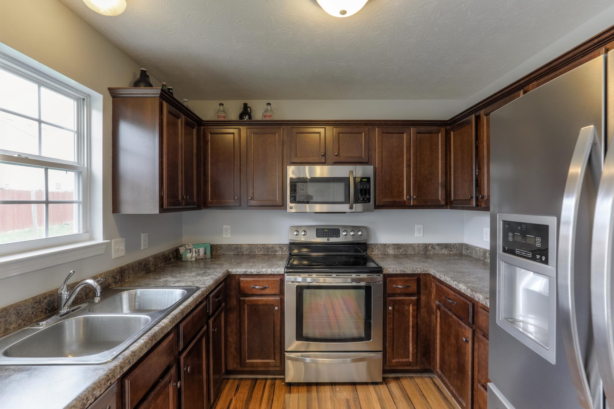 1118 Woodall Road Lebanon, TN 37090 - Photo 11 of 25 a kitchen with granite countertop a sink wooden cabinets and stainless steel appliances