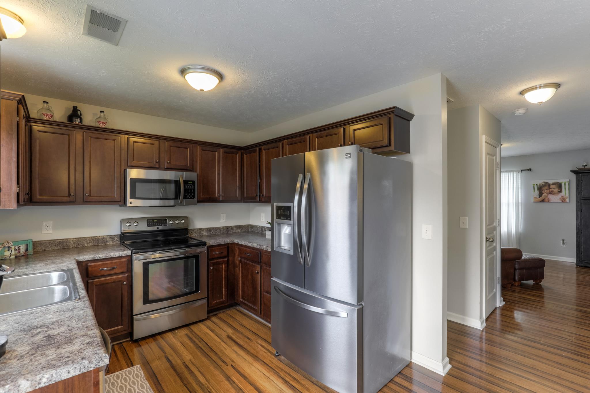 1118 Woodall Road Lebanon, TN 37090 - Photo 12 of 25 a kitchen with stainless steel appliances granite countertop a refrigerator stove and sink