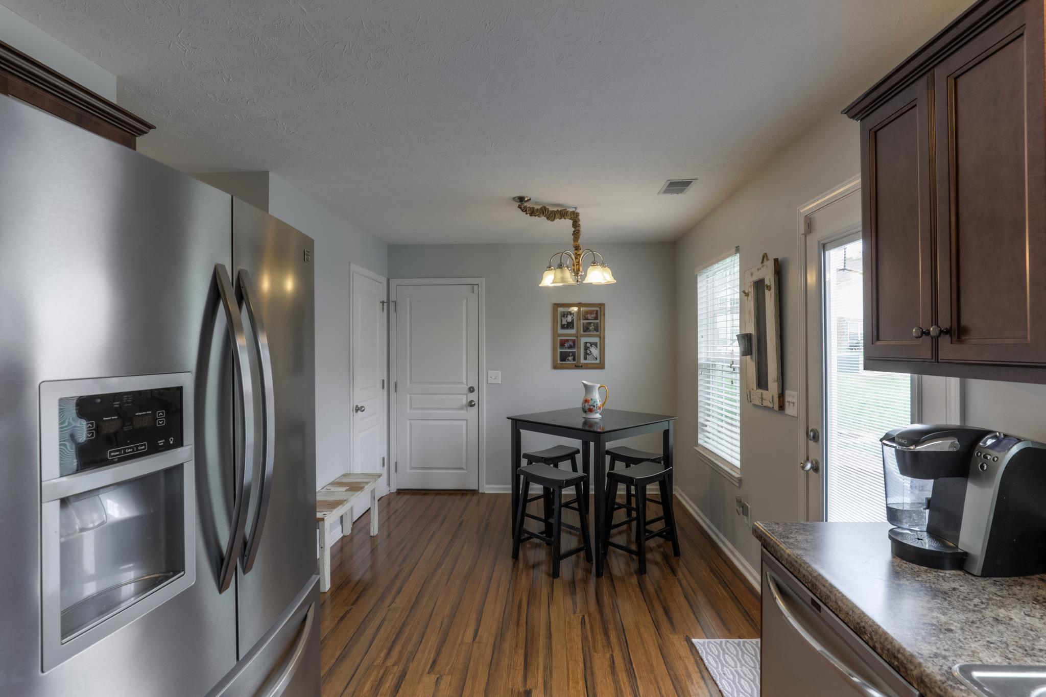 1118 Woodall Road Lebanon, TN 37090 - Photo 13 of 25 a kitchen with granite countertop a refrigerator and wooden floor