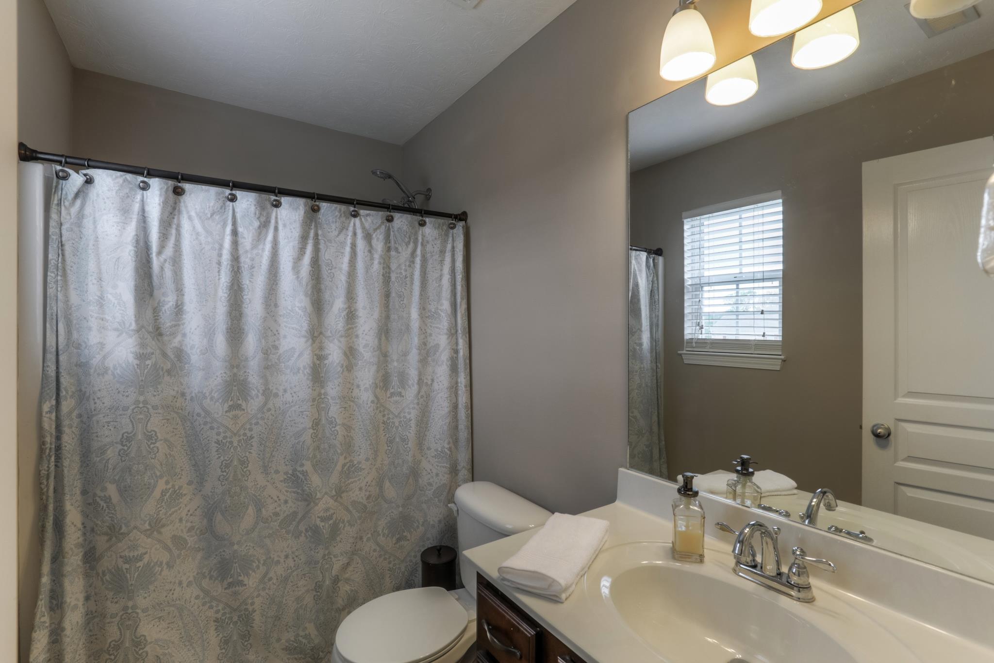 1118 Woodall Road Lebanon, TN 37090 - Photo 17 of 25 a bathroom with a sink toilet and a mirror