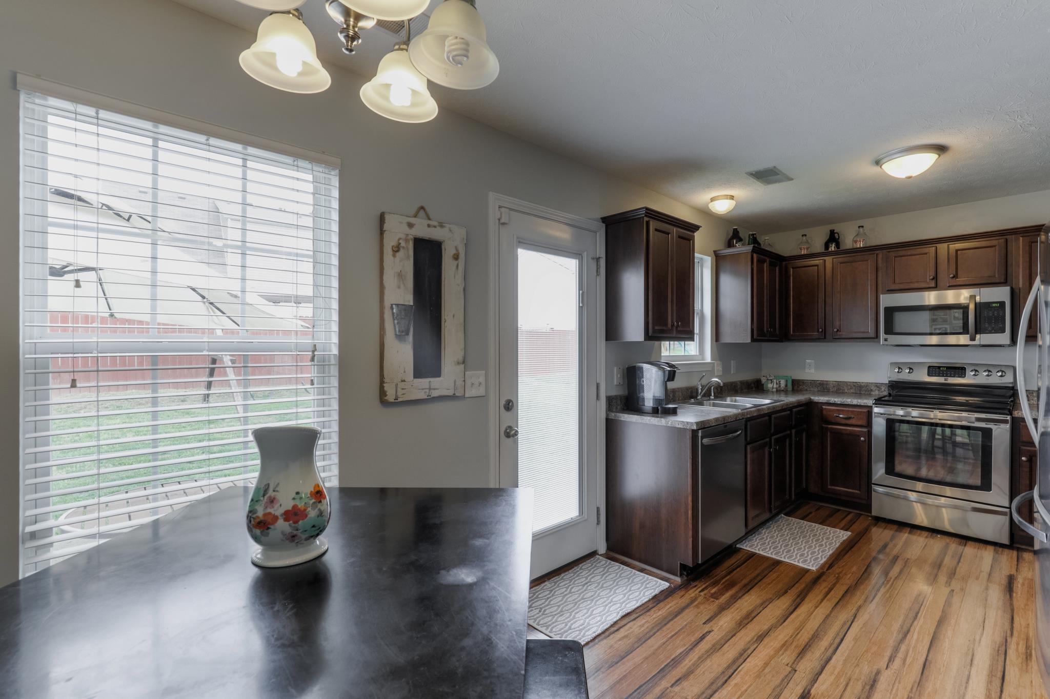 1118 Woodall Road Lebanon, TN 37090 - Photo 9 of 25 a kitchen with stainless steel appliances granite countertop a stove and cabinets