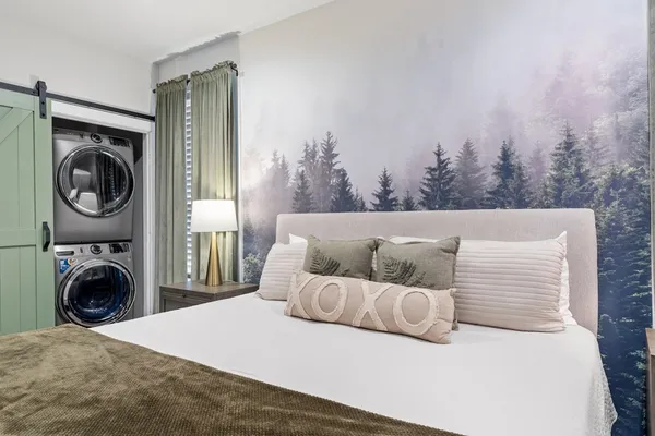 a view of a bedroom with furniture and a fireplace