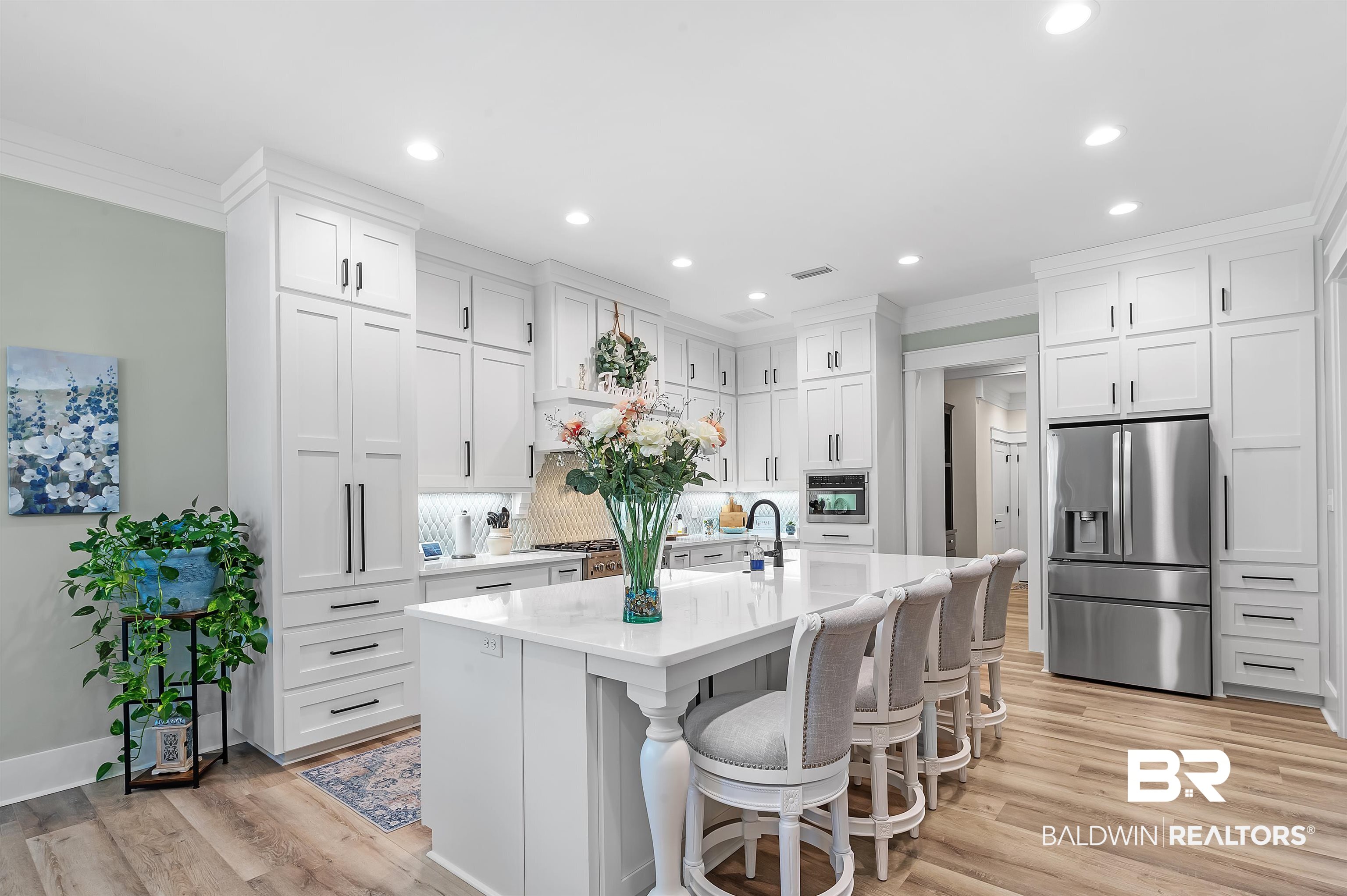 9144 Harvest Ridge Fairhope, AL 36532 - Photo 24 of 58 Kitchen featuring light wood finished floors, white cabinetry, light countertops, and appliances with stainless steel finishes