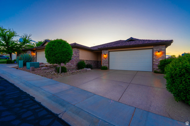 2212 Chippenham Court St. George, UT 84770 - Photo 4 of 75 View of front of home featuring a garage, brick siding, and concrete driveway