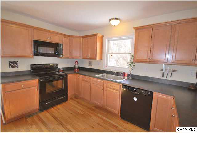 112 Roy's Place Charlottesville, VA 22902 - Photo 5 of 14 a kitchen with stainless steel appliances granite countertop a stove a sink and a microwave
